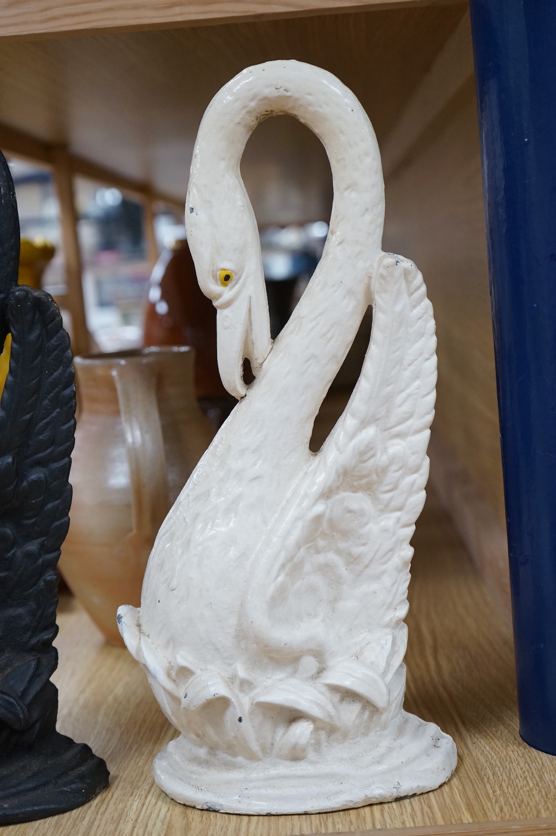 Two Victorian cast iron ‘swan’ door stops, one painted, 38cm
